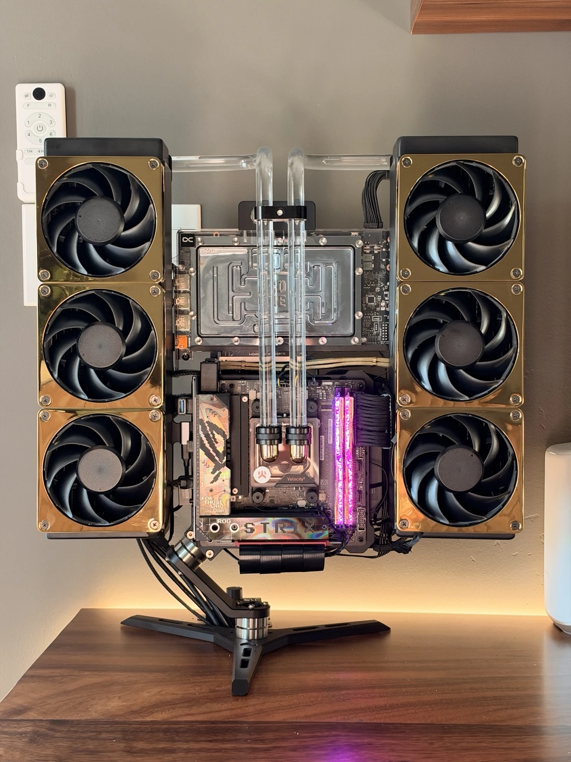 Straight-on view of the black and gold 5090 build with visible fan blades and custom tubing