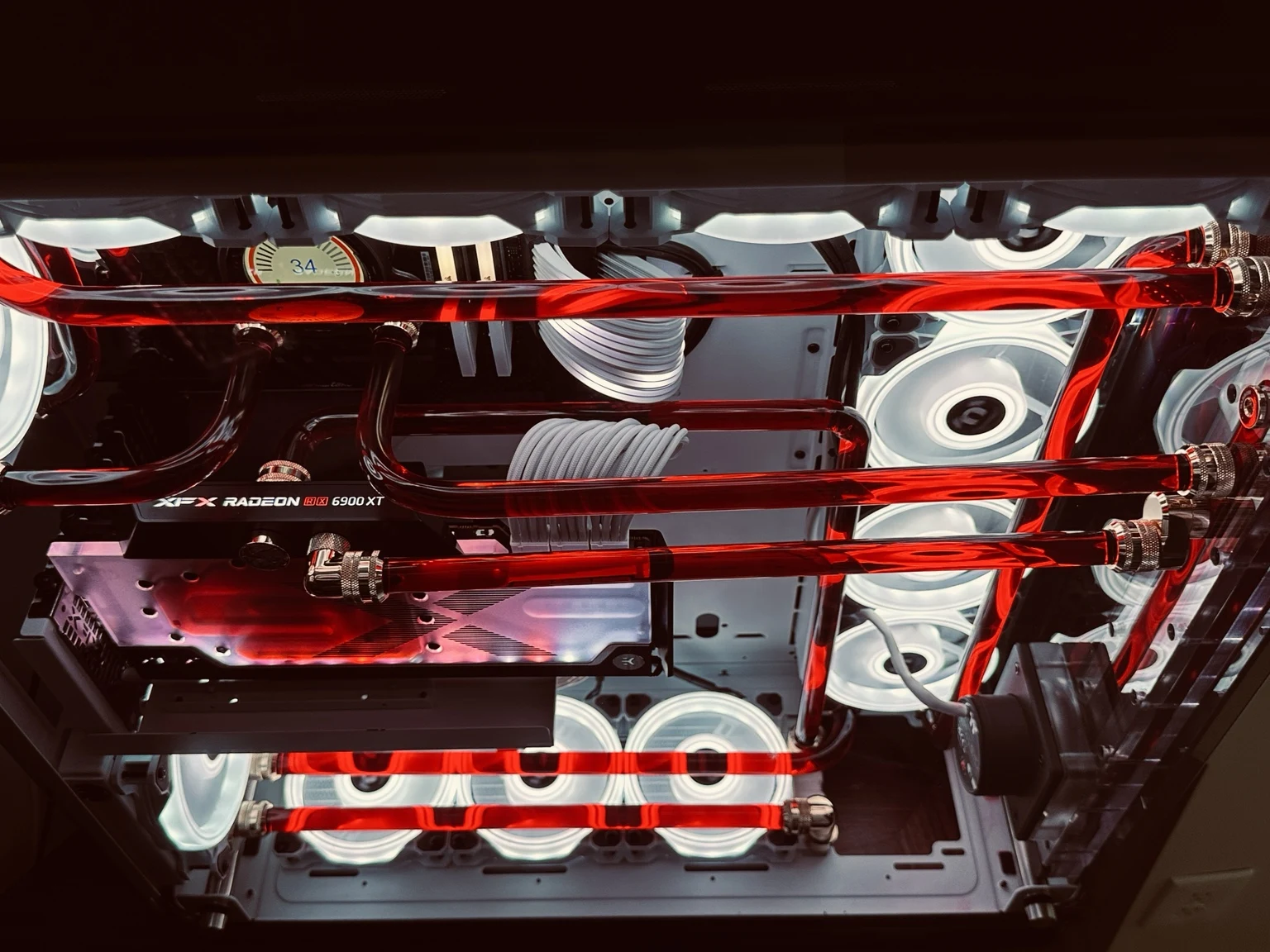 Thermaltake Core P8 custom PC with red coolant, white sleeved cables, and custom hard tubing
